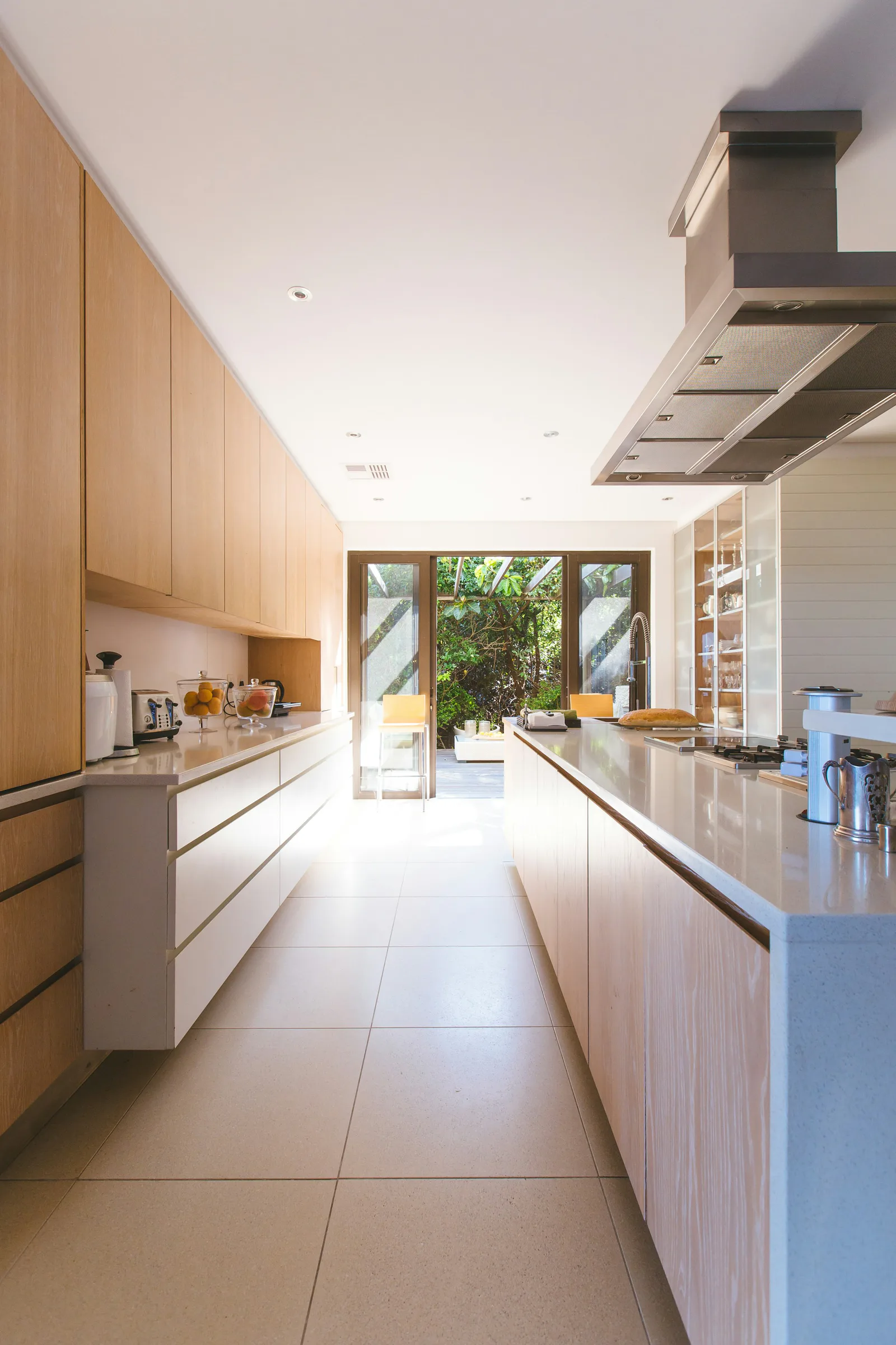Bright, well-kept residential kitchen with natural wood cabinetry